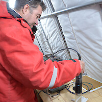 Geologists test the brine samples at the drill platform